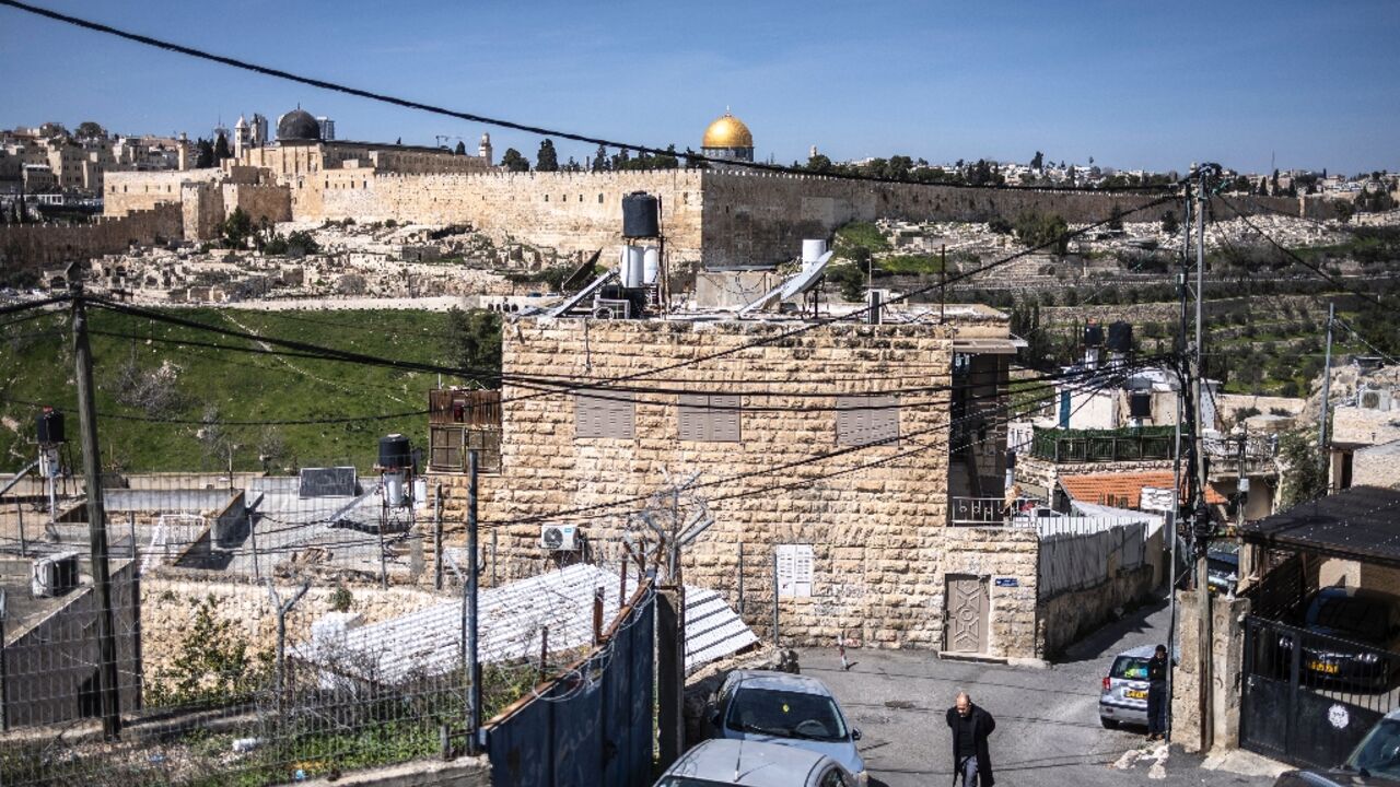 A resident walks on a street near Ras al-Amud Mosque in Israeli-annexed east Jerusalem, overlooking the Al-Aqsa compound and the Dome of the Rock on March 6