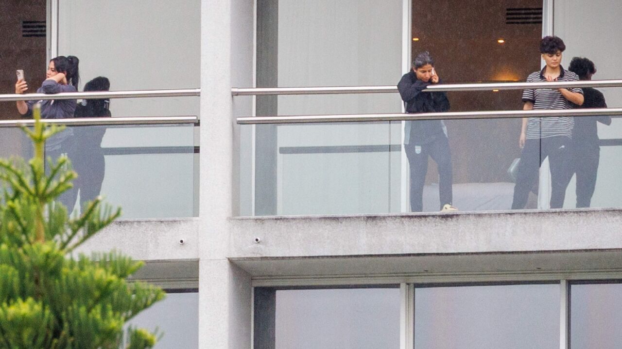Members of the Iranian women’s football team are seen on their respective room balconies at the Royal Pines Resort on the Gold Coast on March 9, 2026