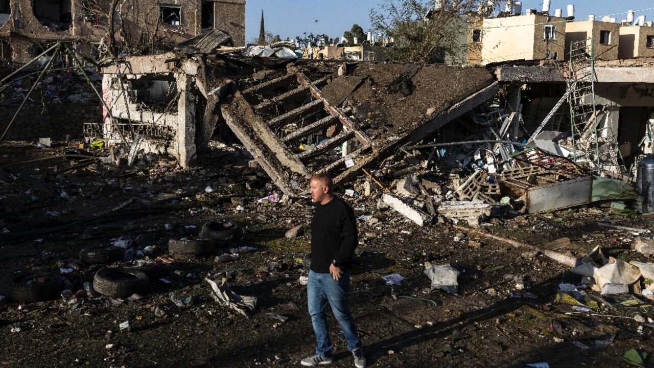 A man surveys the damage in Dimona after Iranian missiles slipped through air defences and struck two towns in southern Israel