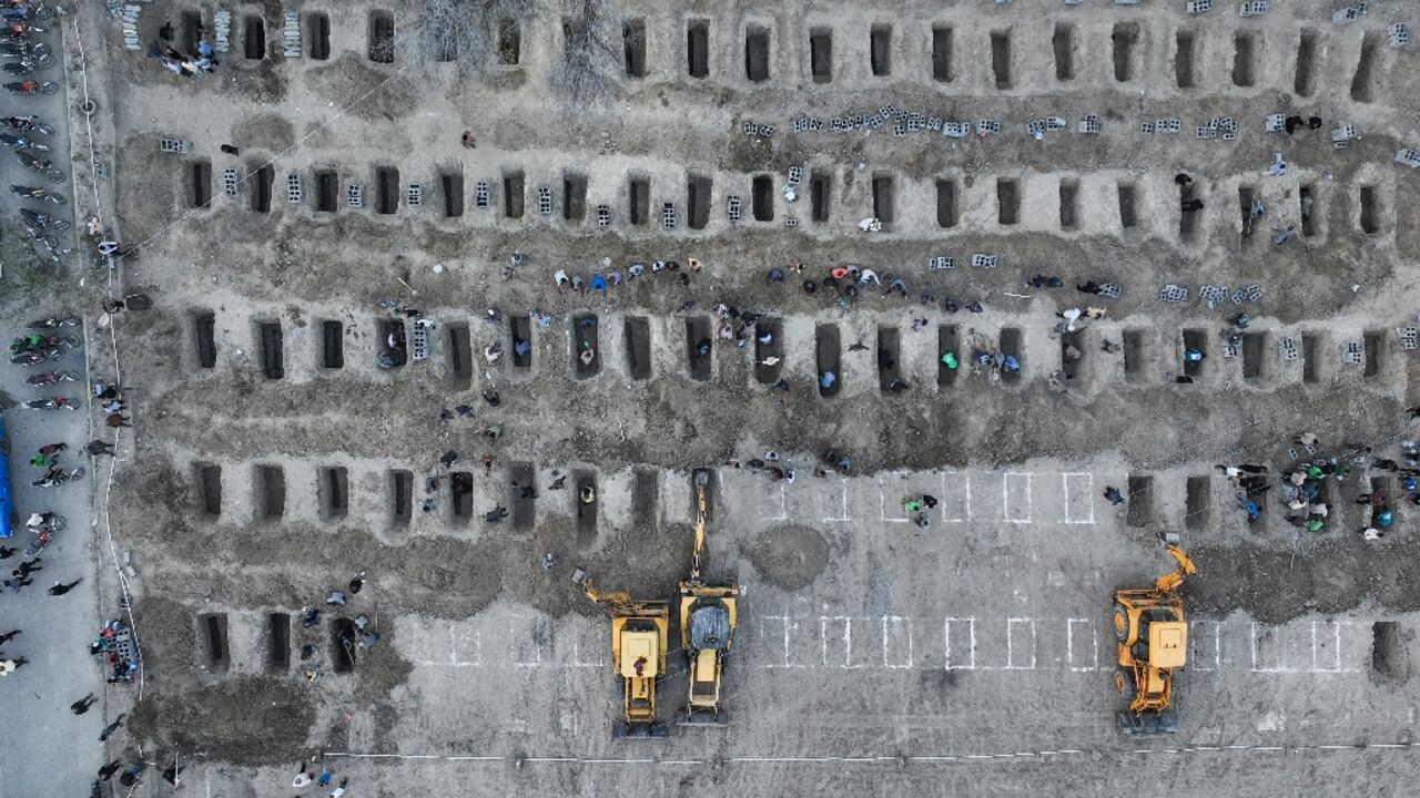 Graves are dug for children reportedly killed in a school strike in Minab, an image from the Iranian Press Center shows 