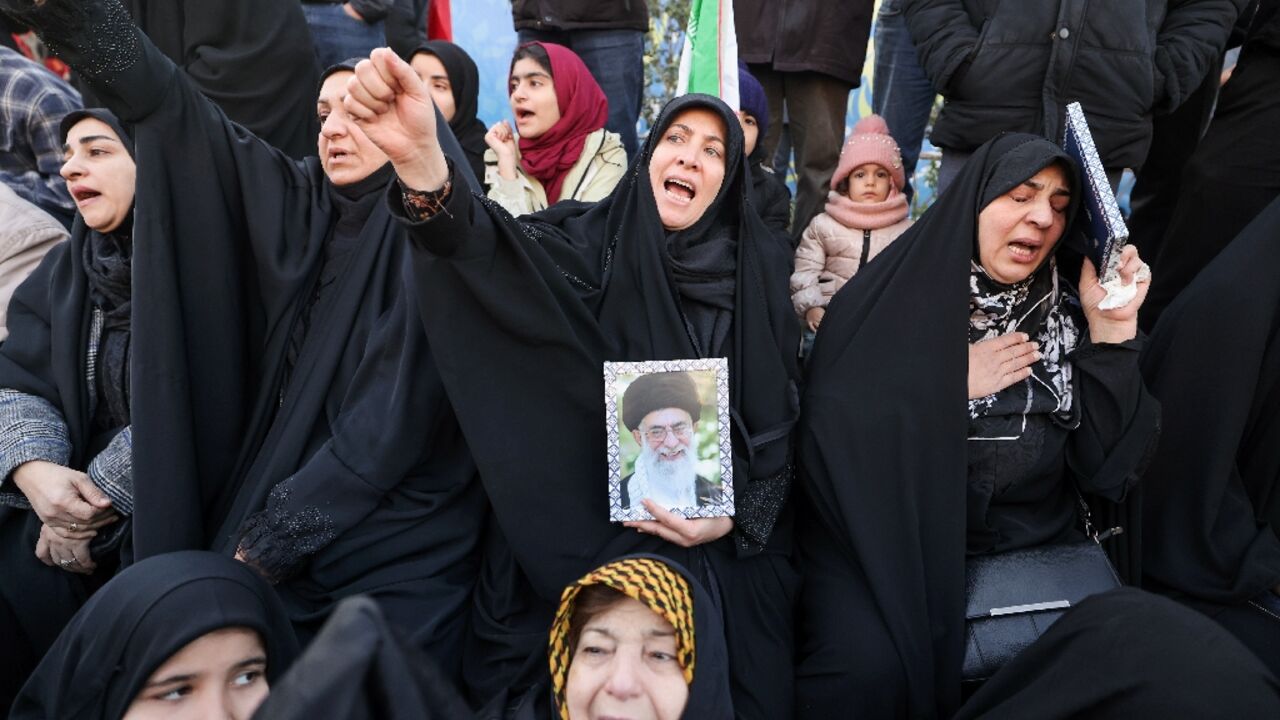 People mourn the death of Iran's supreme leader Ayatollah Ali Khamenei at a square in Tehran