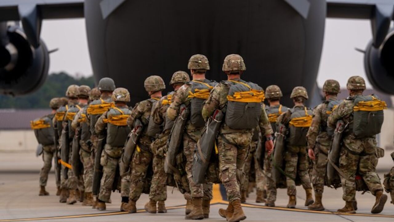 Paratroopers assigned to the 82nd Airborne Division walk to a C-17 Globemaster III before an airborne operation at Fort Bragg, North Carolina, March 13, 2025.