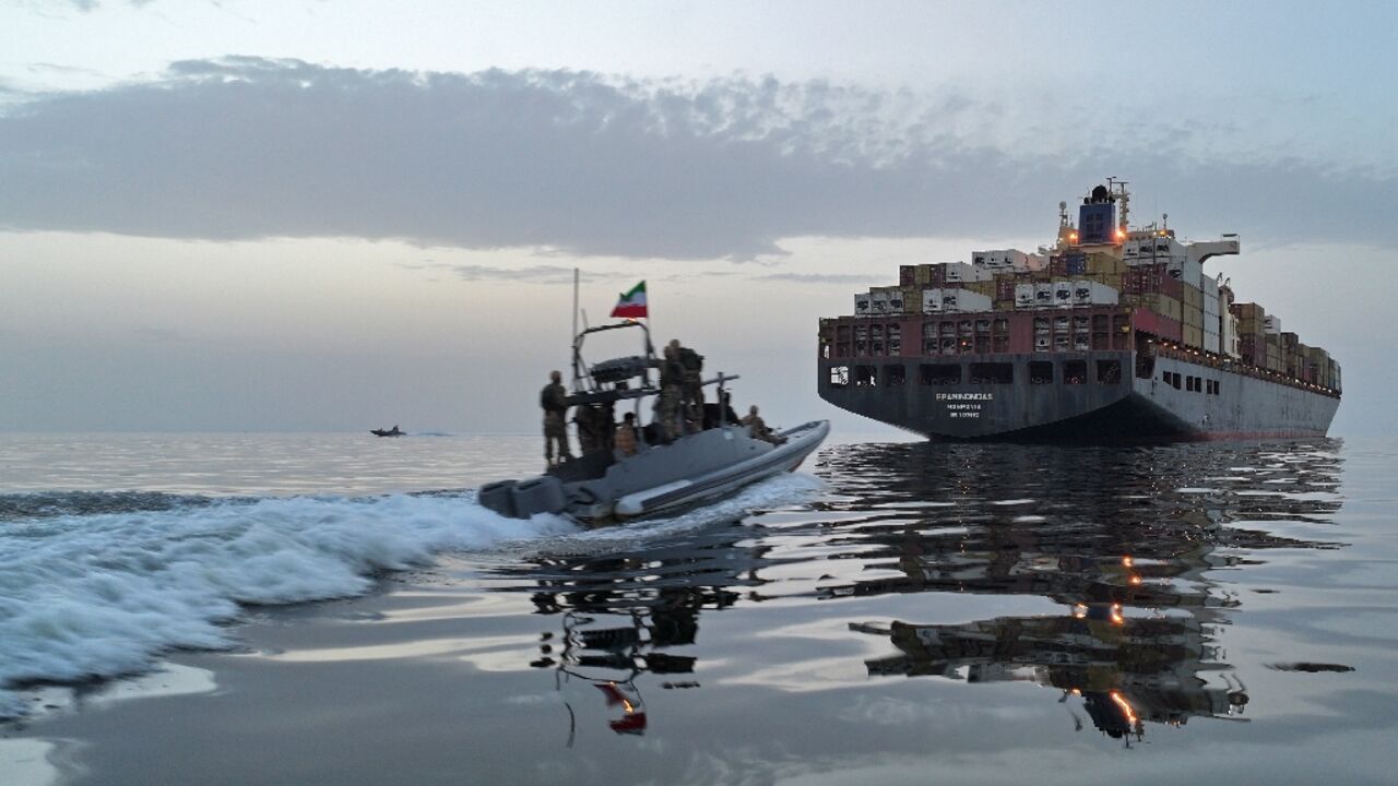 This photo obtained by AFP from the Iranian news agency Tasnim shows an Islamic Revolutionary Guard Corps (IRGC) boat allegedly taking part in an operation to seize ships attempting to cross the Strait of Hormuz, on April 21, 2026