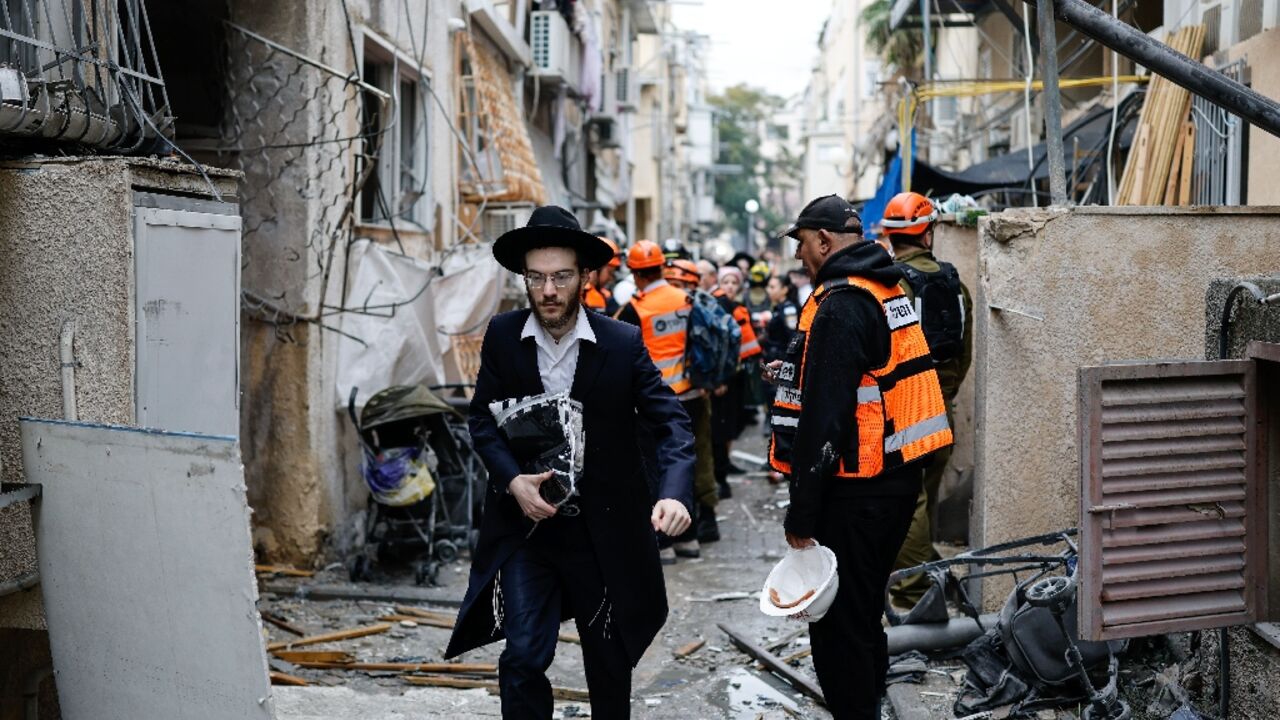 Residents and first responders at the scene following an Iranian strike in Bnei Brak in central Israel on Wednesday