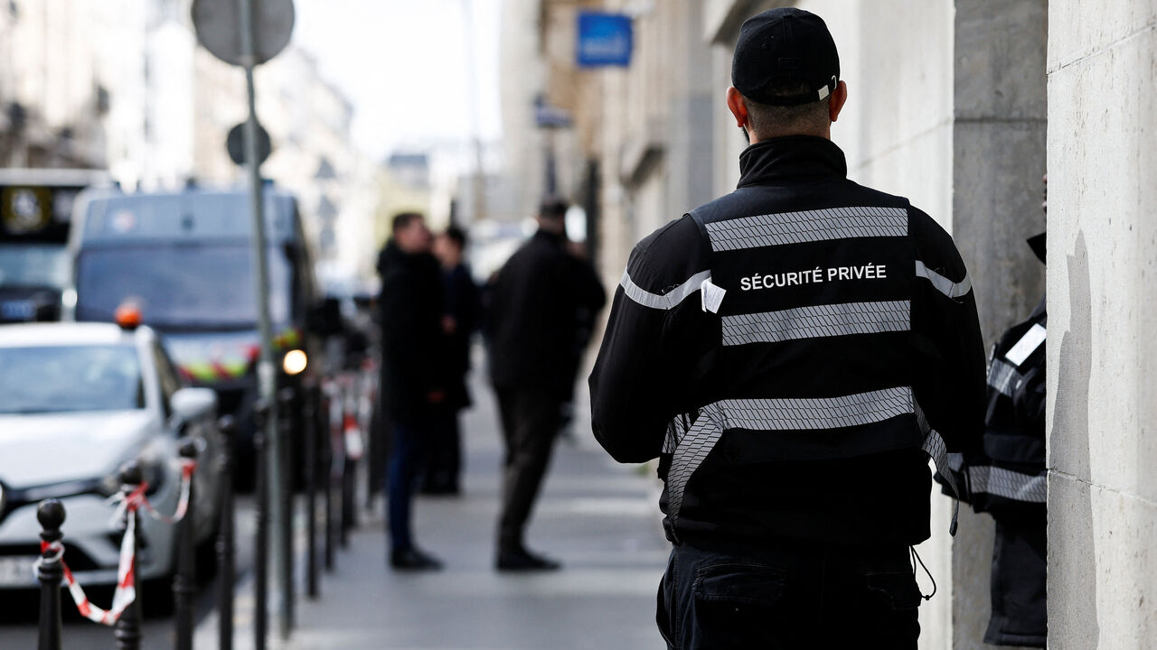 A private security member stands outside Bank of America’s Paris offices, after French anti-terrorism prosecutors opened an investigation into attempted destruction by fire or other dangerous means in Paris, France, March 30, 2026. REUTERS/Benoit Tessier