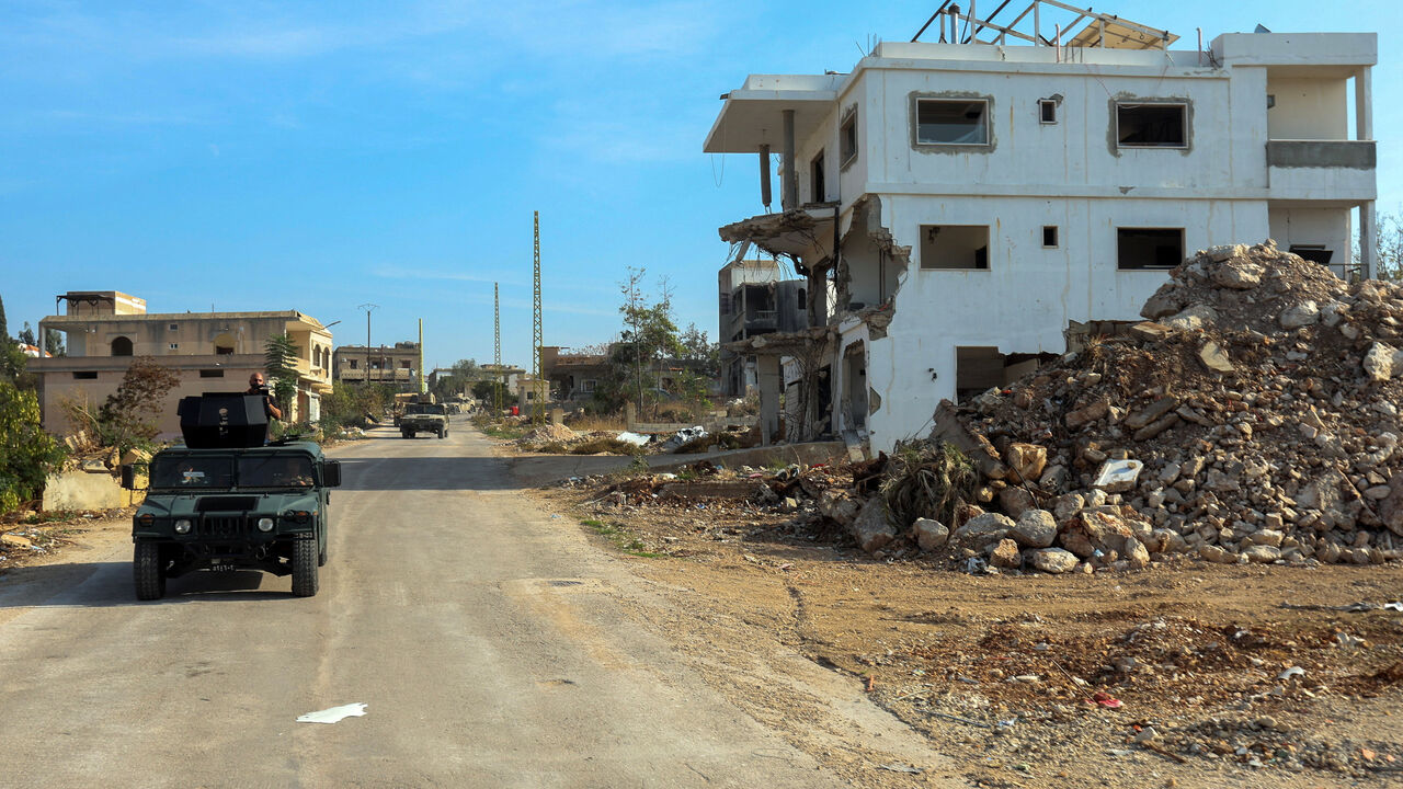 FILE PHOTO: Lebanese army vehicles pass by a damaged building in Naqoura, Lebanon, November 28, 2025. REUTERS/Aziz Taher/File Photo