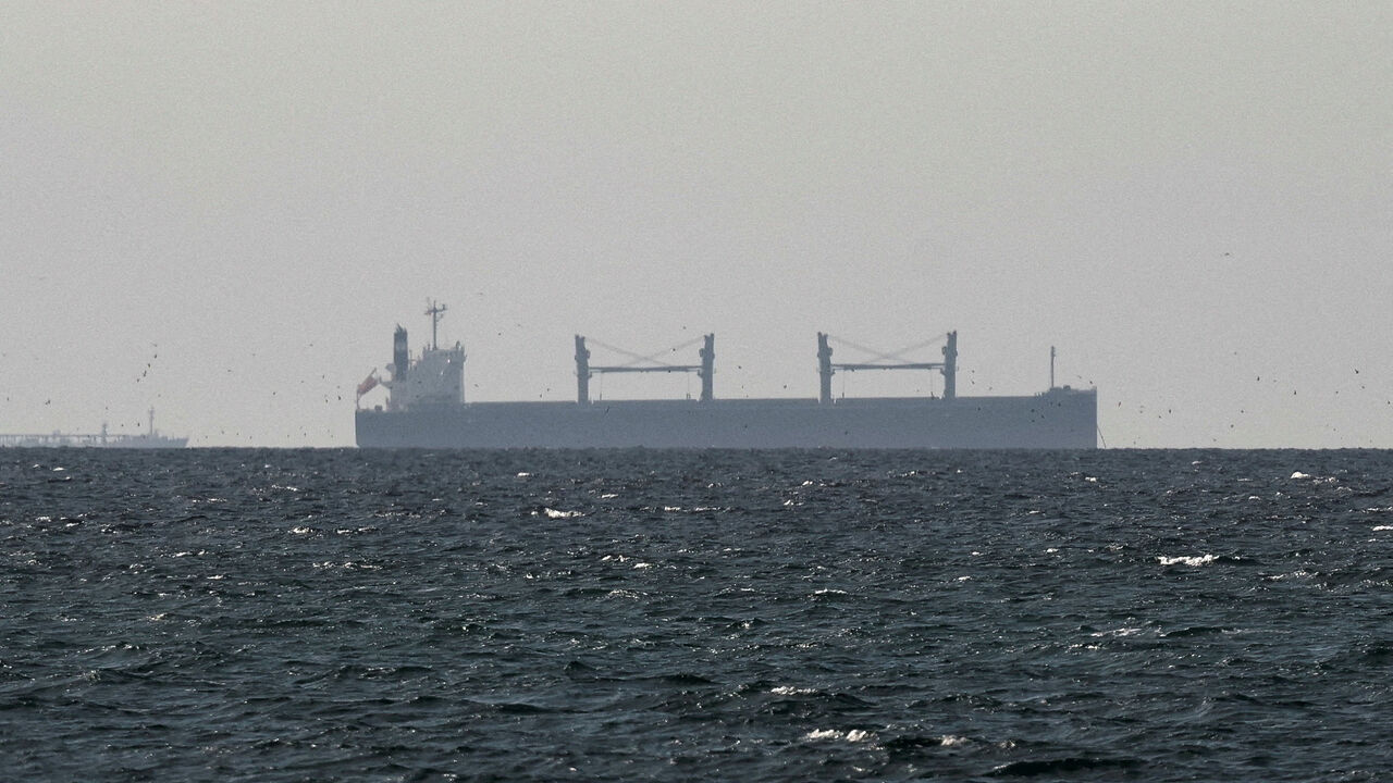 FILE PHOTO: A cargo ship in the Gulf, near the Strait of Hormuz, as seen from northern Ras al-Khaimah, near the border with Oman’s Musandam governance, amid the U.S.-Israeli conflict with Iran, in United Arab Emirates, March 11, 2026. REUTERS/Stringer/File Photo
