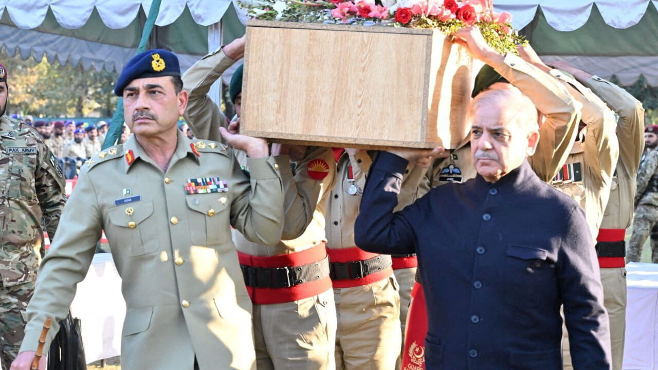 FILE PHOTO: Pakistan's Chief of Army Staff (COAS) Asim Munir and Prime Minister Shehbaz Sharif carry the coffin of a soldier who was killed during clashes between security forces and protesters who were demanding the release of former Prime Minister Imran Khan in Islamabad, at Chaklala Garrison in Rawalpindi, Pakistan, November 26, 2024. Press Information Department (PID)/Handout via REUTERS/File Photo