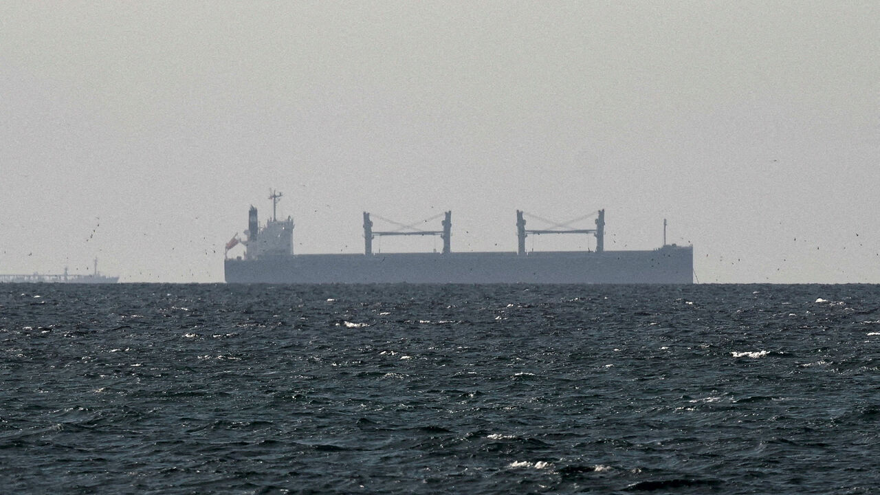 FILE PHOTO: A cargo ship in the Gulf, near the Strait of Hormuz, as seen from northern Ras al-Khaimah, near the border with Oman’s Musandam governance, amid the U.S.-Israeli conflict with Iran, in United Arab Emirates, March 11, 2026. REUTERS/Stringer/File Photo