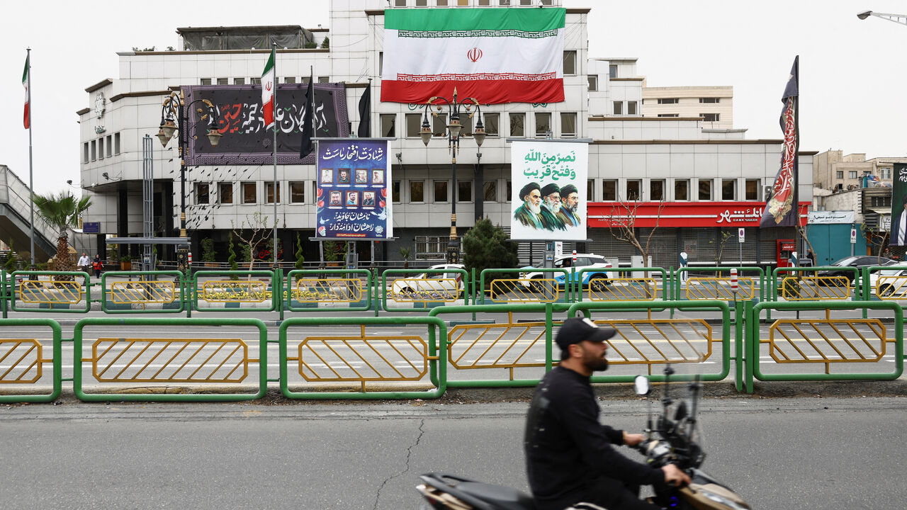 A banner with a picture of the late leader of the Islamic Revolution, Ayatollah Ruhollah Khomeini, and the late Supreme Leader of Iran, Ayatollah Ali Khamenei and Iran's new Supreme Leader, Mojtaba Khamenei, is displayed on a street, amid the U.S.-Israeli conflict with Iran, in Tehran, Iran, March 23, 2026. Majid Asgaripour/WANA (West Asia News Agency) via REUTERS