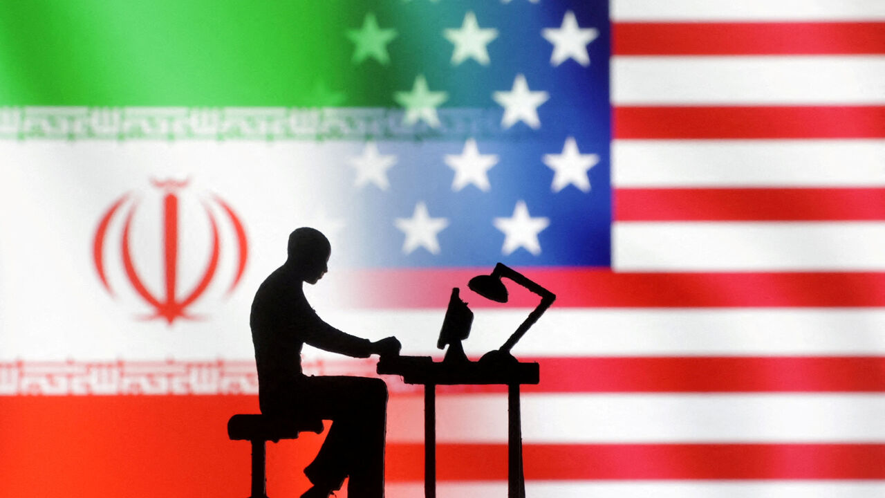 FILE PHOTO: Figurines with computers are seen in front of USA and Iran flags in this illustration created on September 10, 2022. REUTERS/Dado Ruvic/Illustration/File Photo