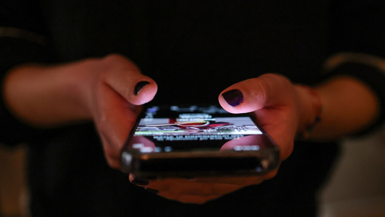 A girl checks social media posts on her phone, as Greece is set to ban under-15s from social media in European crackdown, in Athens, Greece, April 1, 2026. REUTERS/Louisa Gouliamaki