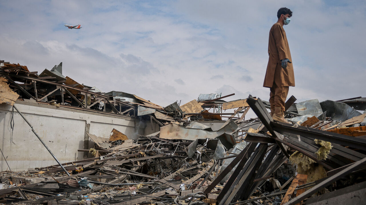 A man stands on the debris at the site of a drug rehabilitation hospital destroyed in what the Taliban said was a Pakistani air strike in Kabul, Afghanistan, March 17, 2026. REUTERS/Sayed Hassib