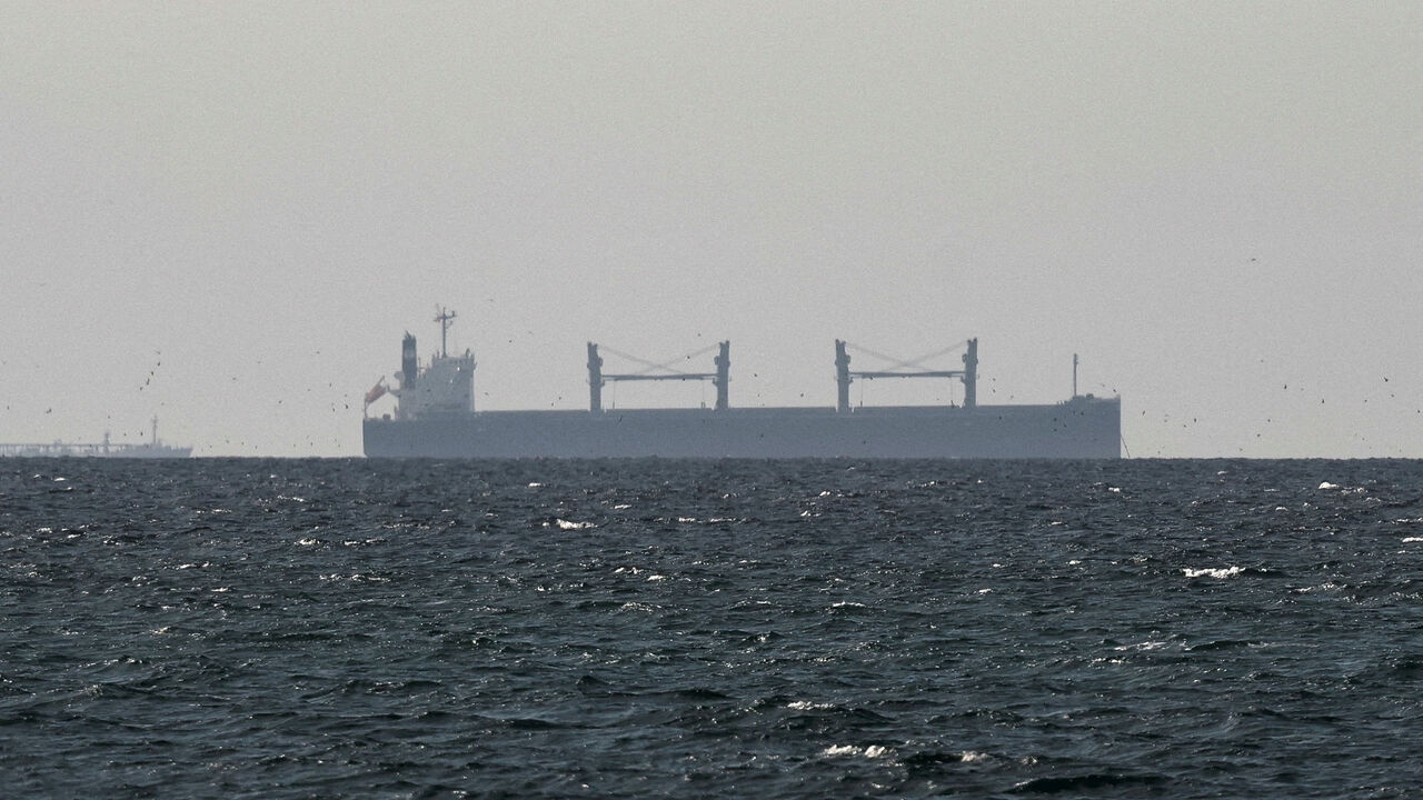FILE PHOTO: A cargo ship in the Gulf, near the Strait of Hormuz, as seen from northern Ras al-Khaimah, near the border with Oman’s Musandam governance, amid the U.S.-Israeli conflict with Iran, in United Arab Emirates, March 11, 2026. REUTERS/Stringer/File Photo
