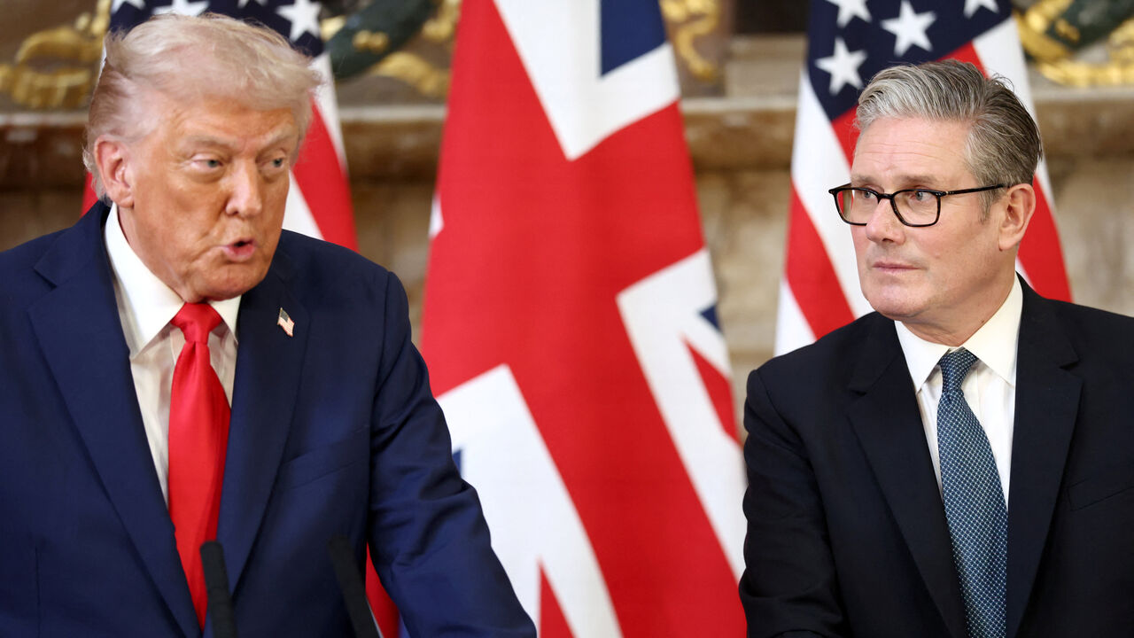 British Prime Minister Keir Starmer listens as U.S. President Donald Trump speaks during a press conference following their meeting at Chequers, near Aylesbury, Britain, September 18, 2025. REUTERS/Kevin Lamarque