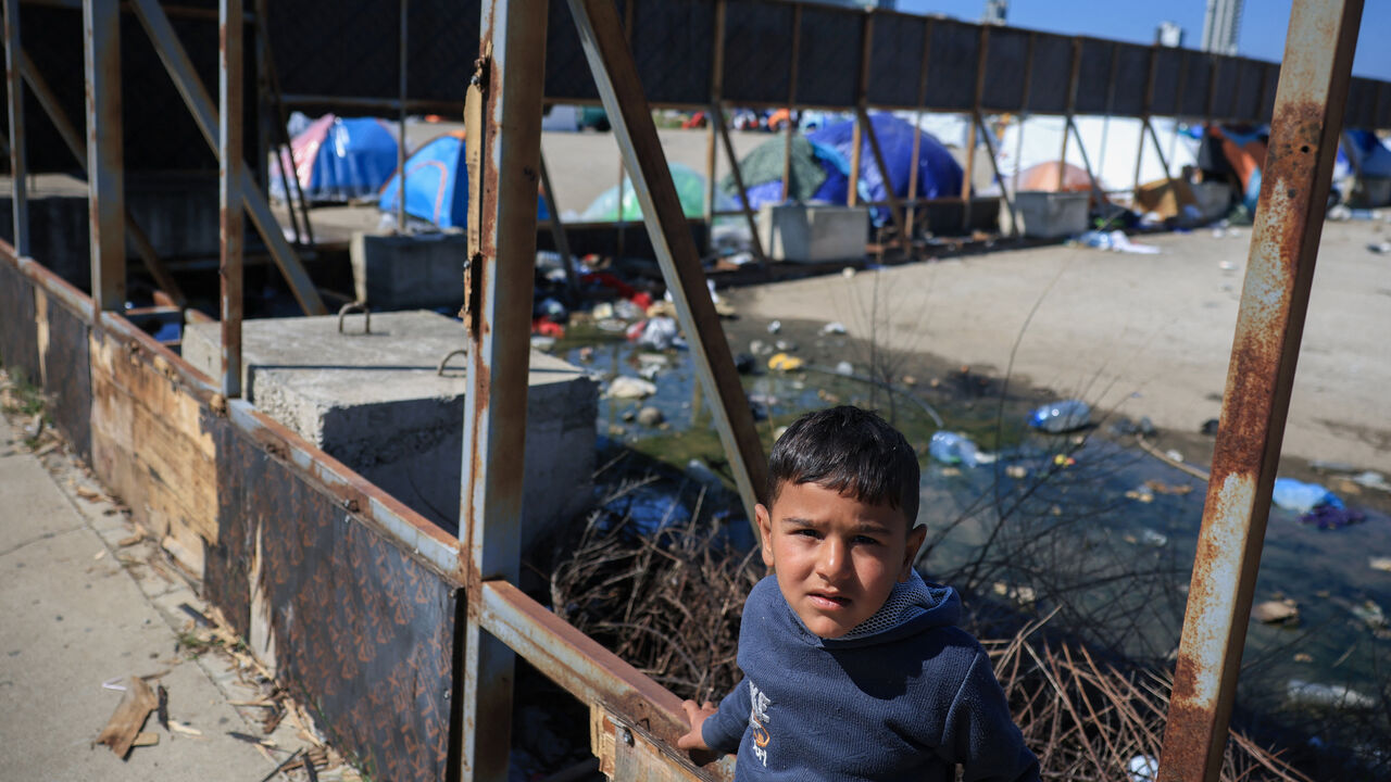A child looks on at the makeshift encampment, by people who fled their homes after Israeli evacuation orders, in Beirut, Lebanon, April 8, 2026. REUTERS/Louisa Gouliamaki