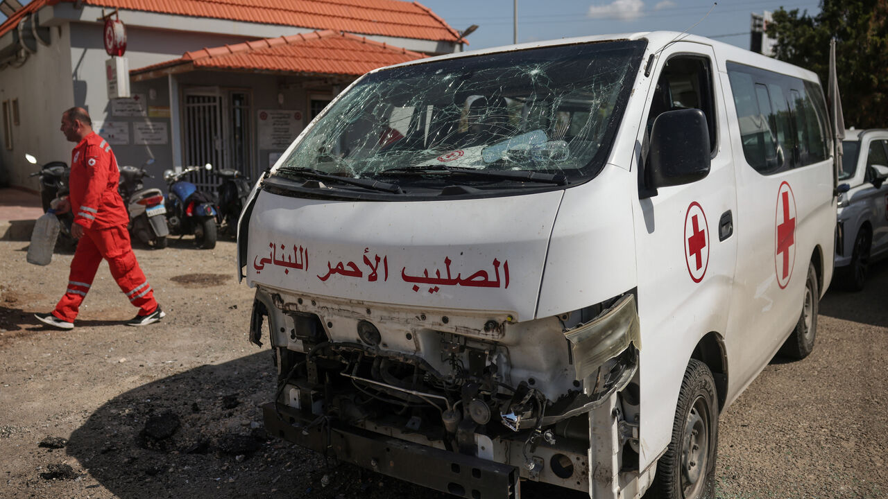 A staff member walks past a damaged Lebanese Red Cross vehicle after a drone strike damaged vehicles and a building, slightly injuring three workers, in Tyre, Lebanon, April 13, 2026. REUTERS/Louisa Gouliamaki