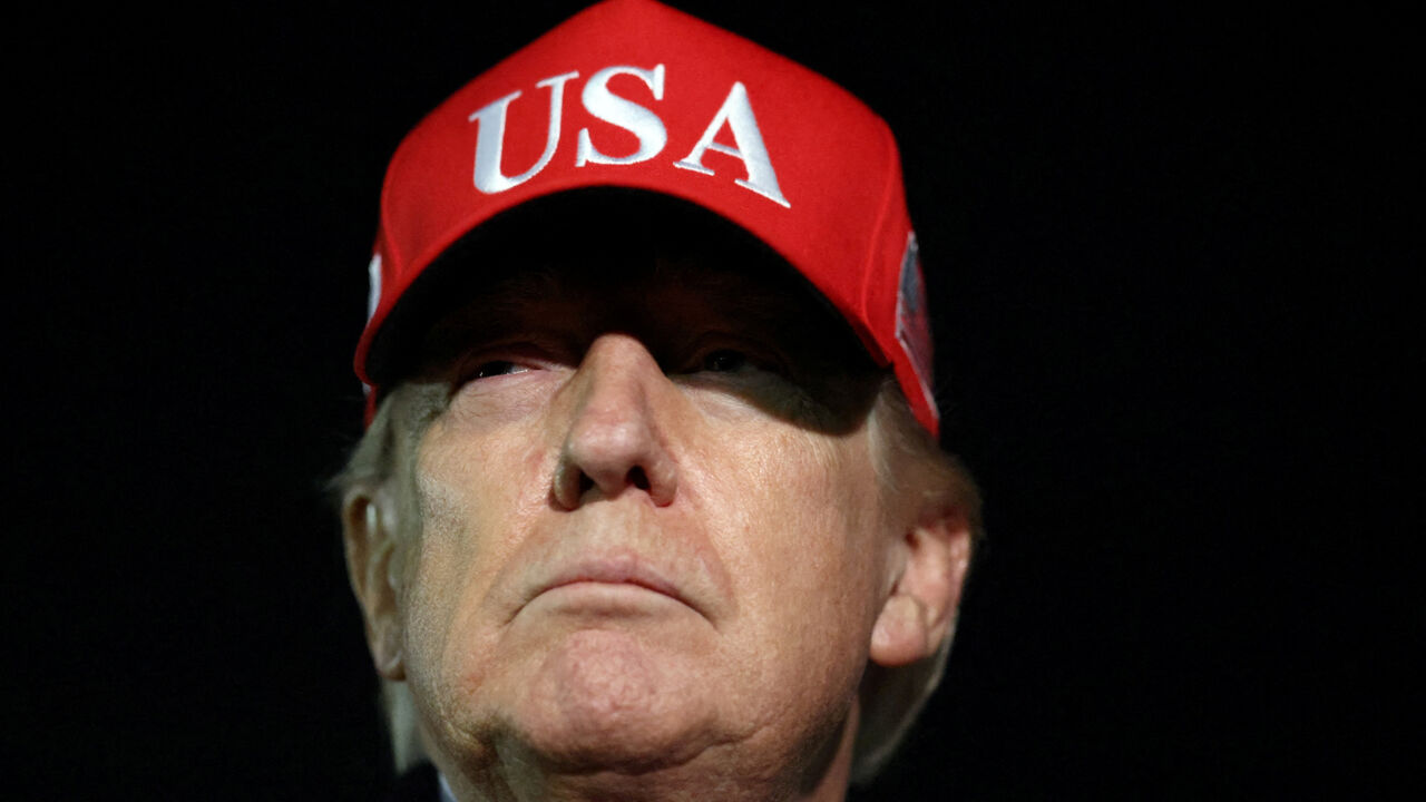 U.S. President Donald Trump looks on after disembarking Air Force One as he arrives at Joint Base Andrews in Maryland, U.S., April 12, 2026.  REUTERS/Kevin Lamarque
