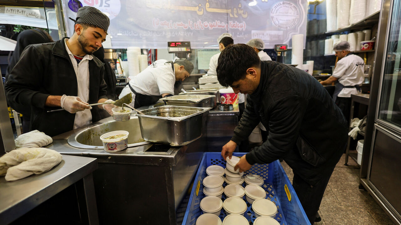 Workers prepare food at a restaurant, amid heightened tensions linked to the U.S.-Israeli conflict with Iran, in Tehran, Iran, March 13, 2026. REUTERS/Alaa Al Marjani