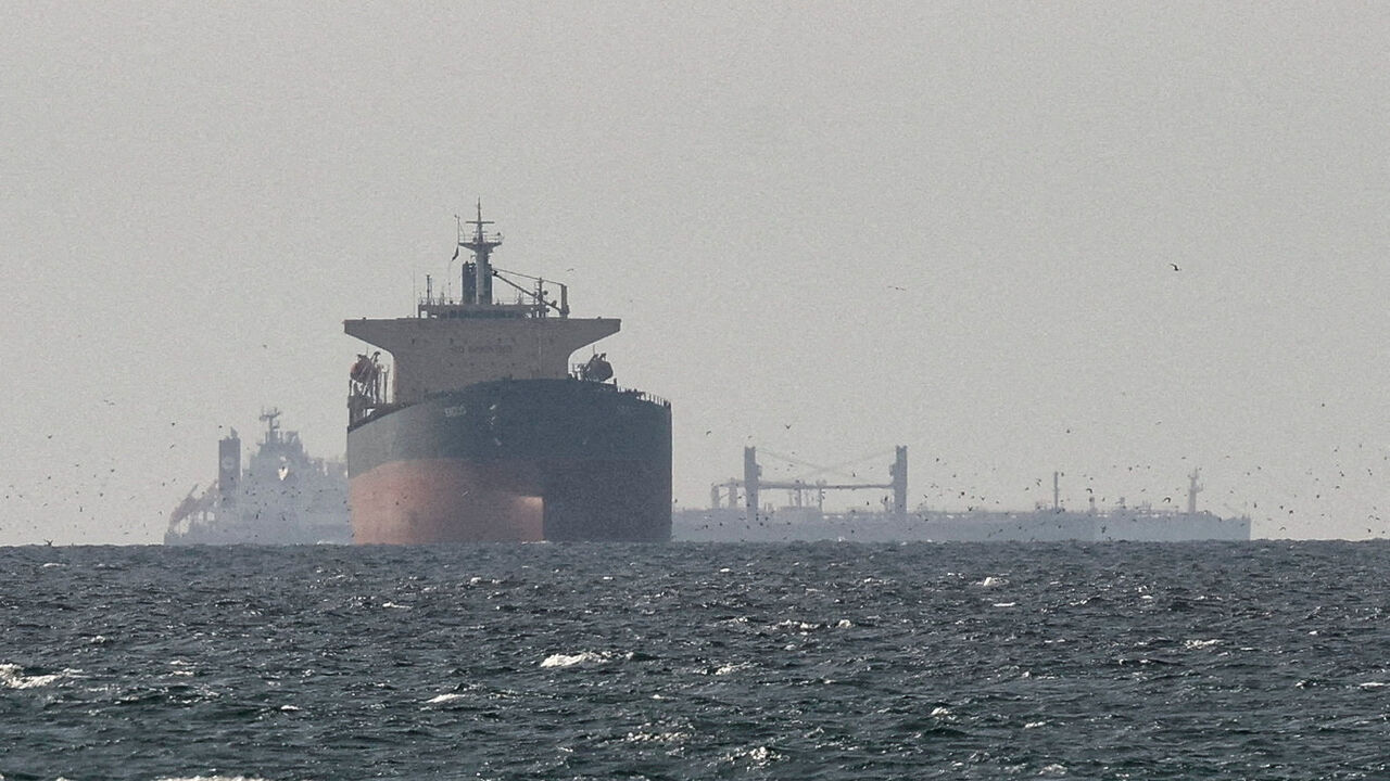 FILE PHOTO: Cargo ships in the Gulf, near the Strait of Hormuz, as seen from northern Ras al-Khaimah, near the border with Oman’s Musandam governance, amid the U.S.-Israeli conflict with Iran, in United Arab Emirates, March 11, 2026. REUTERS/Stringer//File Photo