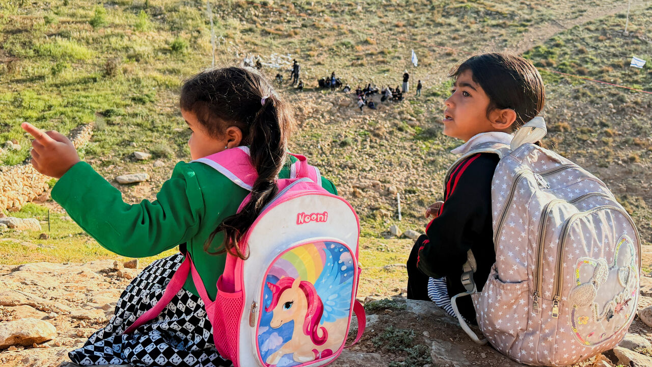 Palestinian students gather near a fence installed by Israeli settlers in their way to school, near Umm al-Khair village in Masafer Yatta, in the Israeli-occupied West Bank, April 14, 2026. Picture taken with a mobile phone. REUTERS/Yosri Aljamal