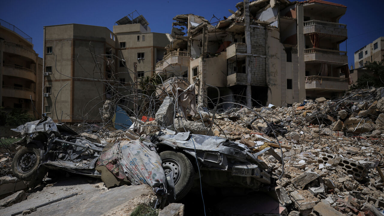 A damaged building, rubble and a destroyed vehicle in the aftermath of Israeli strikes, near Hiram Hospital in Tyre, south Lebanon, April 16, 2026. REUTERS/Louisa Gouliamaki