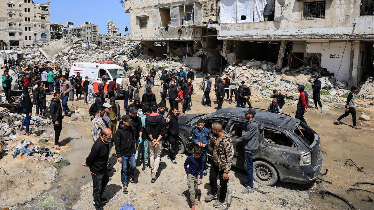 Palestinians inspect the damage after a person was hit by an Israeli strike while riding a bicycle, according to medics, in Gaza City, April 6, 2026. REUTERS/Dawoud Abu Alkas
