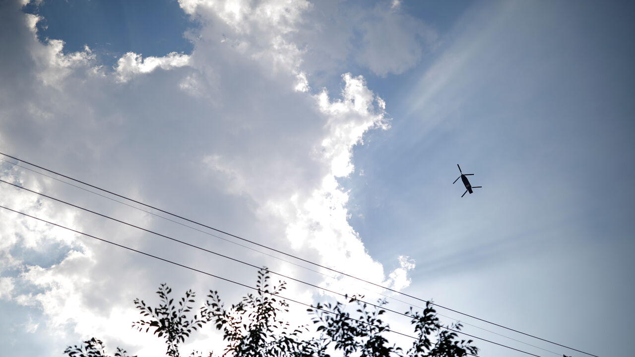 FILE PHOTO: A military helicopter carrying a container flies toward a golf course where a Terminal High Altitude Area Defense (THAAD) system is deployed, in Seongju, South Korea, June 14, 2017.  REUTERS/Kim Hong-Ji/File Photo