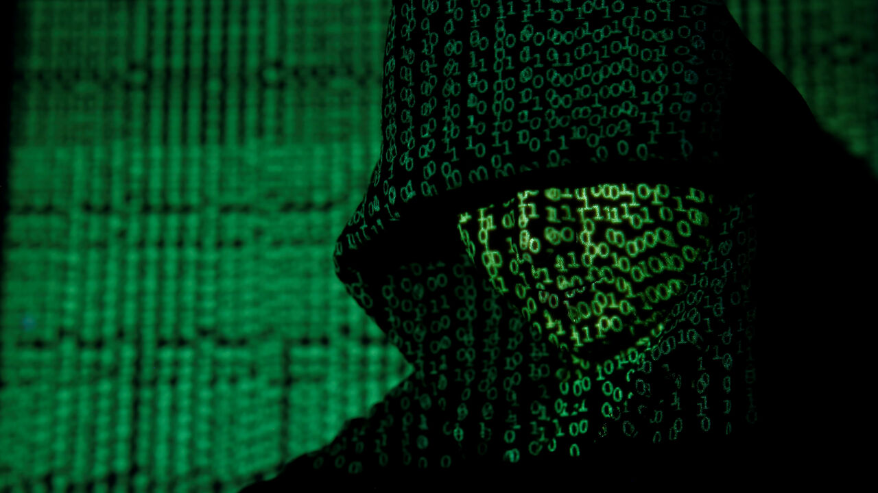 A projection of cyber code on a hooded man is pictured in this illustration picture taken on May 13,  2017. REUTERS/Kacper Pempel/Illustration/File Photo