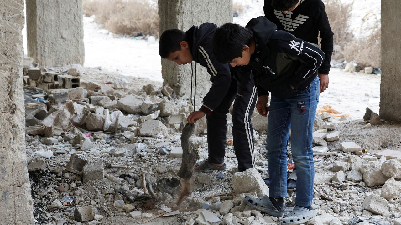 FILE PHOTO: Kids search and inspect bones amidst rubbles in Tadamon district, which is littered with bones after what residents and rights groups described as years of killings there under the rule of Syria's Bashar al-Assad, following al-Assad's ousting by fighters of the ruling Syrian body, in Damascus, Syria, December 12, 2024. REUTERS/Amr Abdallah Dalsh/File Photo