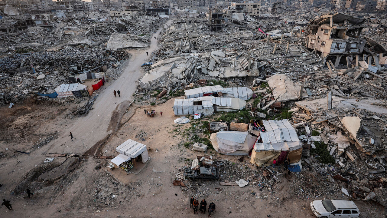 Palestinians gather near the rubble of residential buildings destroyed during the two-year Israeli offensive, on the first day of the holy month of Ramadan, in Gaza City, February 18, 2026. REUTERS/Dawoud Abu Alkas/File Photo
