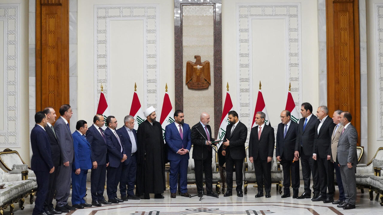 Iraqi President Nizar Amedi and Ali al-Zaidi, the nominee of Iraq's Shiite Coordination Framework for prime minister, stand with political figures during a ceremony where Zaidi was tasked with forming a new government, in Baghdad, Iraq, April 27, 2026. Iraqi President Media Office/Handout via REUTERS ATTENTION EDITORS – THIS IMAGE HAS BEEN SUPPLIED BY A THIRD PARTY