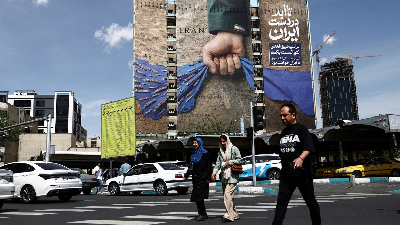 People walk past a billboard with a graphic design about the Strait of Hormuz on a building, amid a ceasefire between U.S. and Iran, in Tehran, Iran, April 27, 2026. Majid Asgaripour/WANA (West Asia News Agency) via REUTERS
