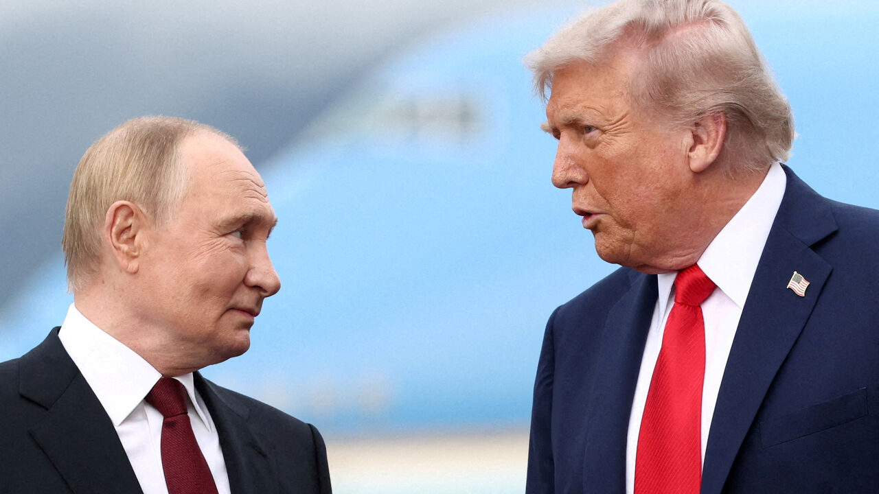 FILE PHOTO: U.S. President Donald Trump speaks with Russian President Vladimir Putin, as they meet to negotiate for an end to the war in Ukraine, at Joint Base Elmendorf-Richardson in Anchorage, Alaska, U.S., August 15, 2025. REUTERS/Kevin Lamarque/File Photo