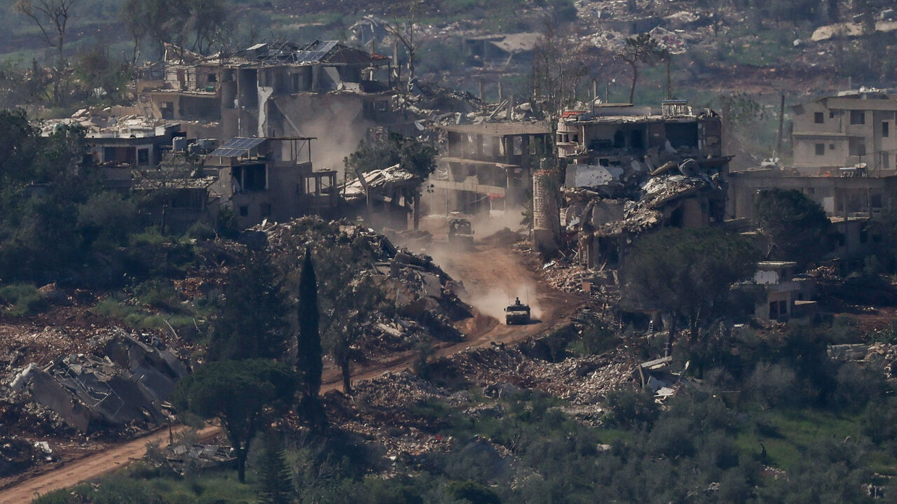 An Israeli military vehicle drives past destroyed buildings in Lebanon, as seen from the Israeli side of the Israel-Lebanon border, April 30, 2026. REUTERS/Shir Torem