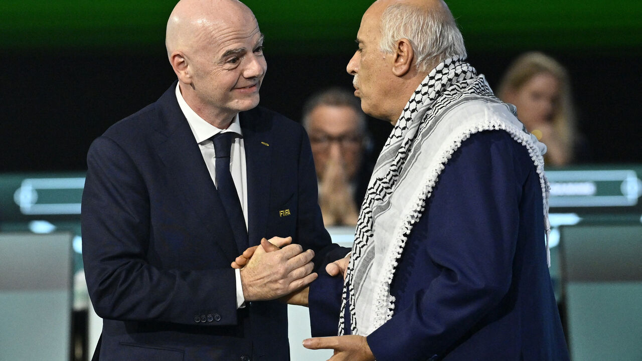 Soccer Football - 76th FIFA Congress - Vancouver Convention Centre, Vancouver, Canada - April 30, 2026  FIFA President Gianni Infantino shakes hands with Jibril Rajoub, President of the Palestine Football association during the congress REUTERS/Jennifer Gauthier