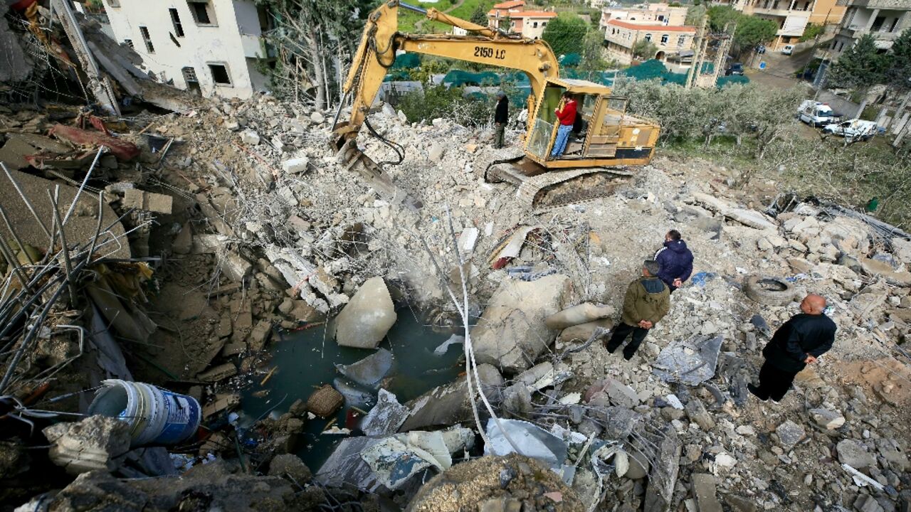 An excavator clears the rubble from the site of an overnight Israeli strike that targeted the southern Lebanese village of Kfar Hatta