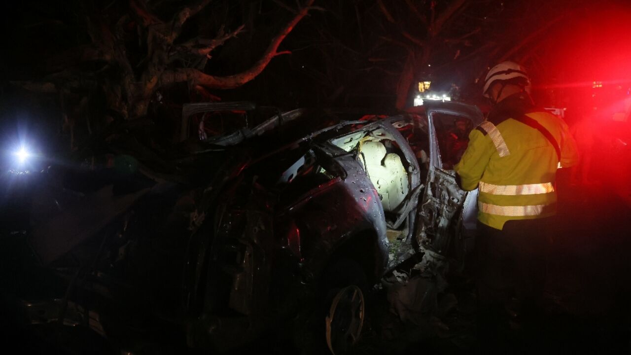 First responders at the site of Israeli strikes in al-Jnah on the outskirts of Beirut's southern suburbs