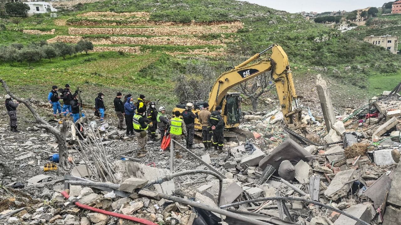 First responders search for survivors at the site of an overnight Israeli airstrike that targeted a house in the southern Lebanese village of Zibdine