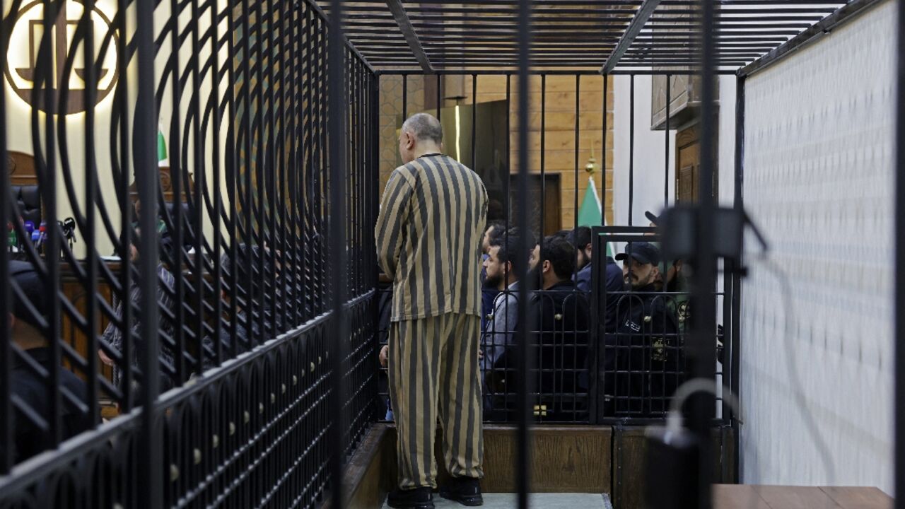 Najib appeared in court in Damascus in a striped prison jersey