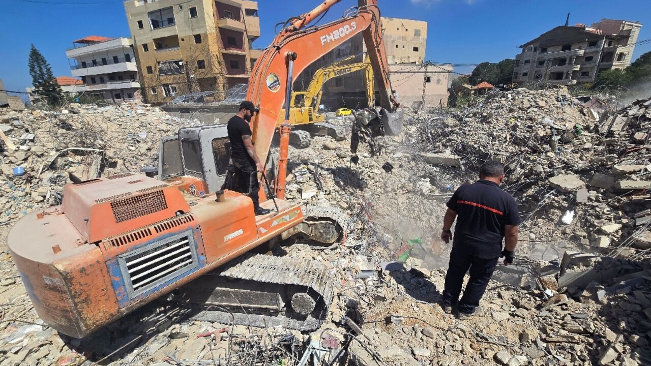 Diggers are used by rescue teams working to remove the rubble from a building previously hit by the Israeli army, in the southern Lebanese village of Hanaouay