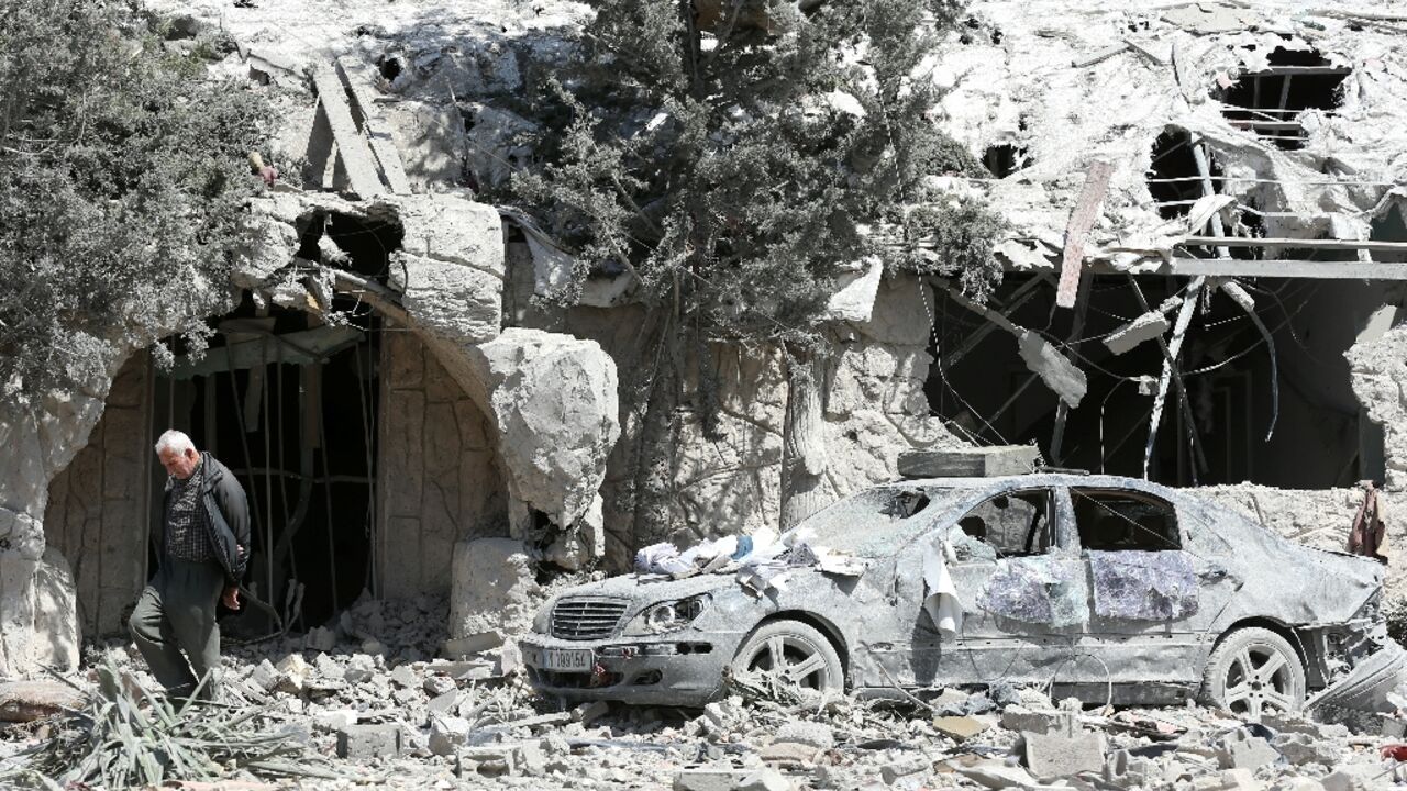 A man checks the site of an Israeli airstrike that targeted a religious Shiite complex the day before in the southern Lebanese coastal city of Sidon