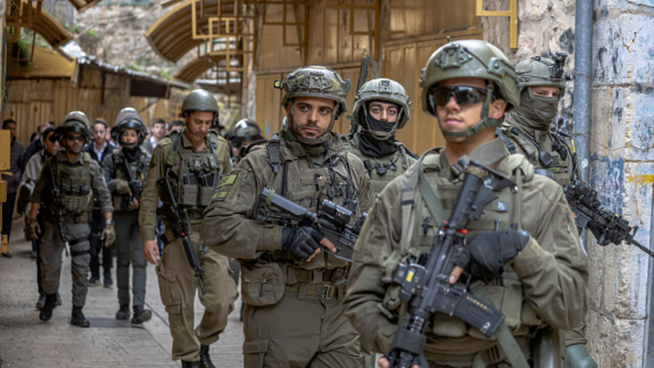 Israeli soldiers patrol a street in Hebron's Old City in the occupied West Bank on January 23, 2026, deployed as settlers entered the area under army protection. (Photo by Mosab Shawer / Middle East Images / AFP via Getty Images)