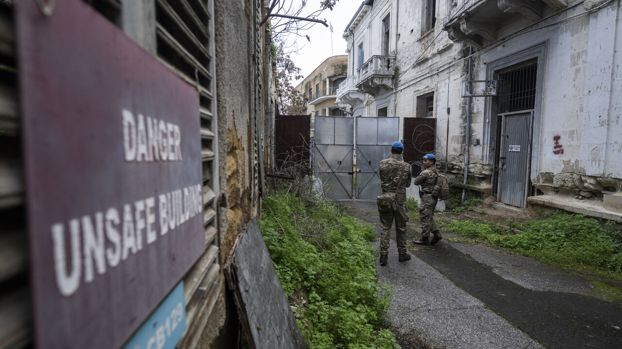 Members of the UN Peacekeeping Force in Cyprus (UNFICYP), from the British Army's 1st Battalion Coldstream Guards, No. 2 Company, patrol along the buffer zone separating the internationally recognized Republic of Cyprus and the breakaway Turkish Republic of Northern Cyprus in the divided capital Nicosia on Feb. 17, 2026. 
