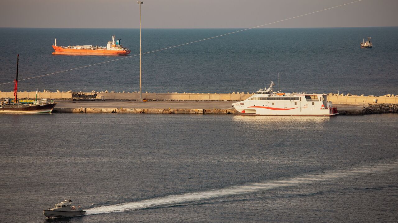 A police speed boat patrols the port as oil tankers and high speed crafts sit anchored at Muscat Anchorage near the Strait of Hormuz on March 30, 2026 in Muscat, Oman.