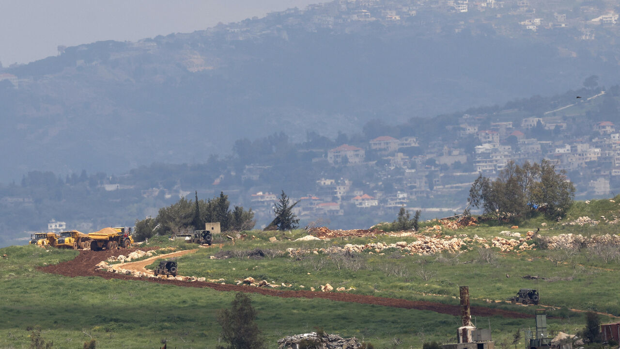 Israeli military vehicles drive along a road in southern Lebanon, near the Israeli border on April 8, 2026. Israel's Defence Minister Israel Katz said the military had carried out a surprise attack on April 8 targeting hundreds of Hezbollah members across Lebanon. (Photo by Jalaa MAREY / AFP via Getty Images) /