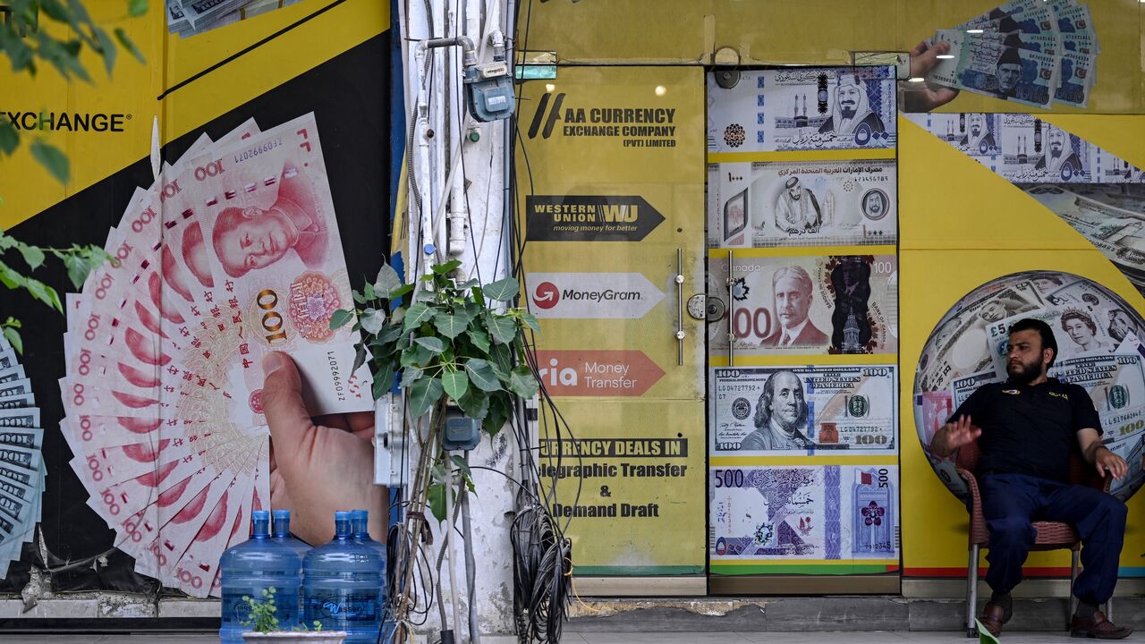 A security personnel sits in a market after markets reopened in Islamabad on April 23, 2026, following heightened security measures amid the ongoing US-Iran peace talks.