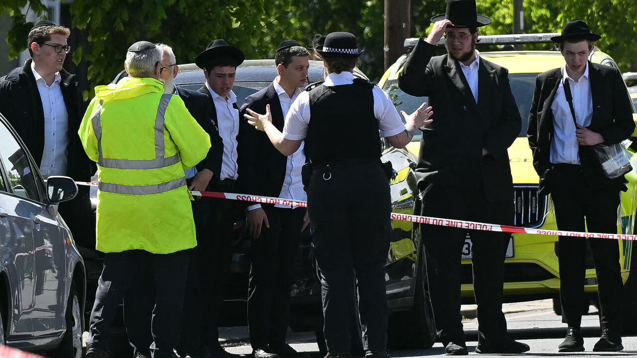 Local residents look on from outside a cordoned off area in the Golders Green neighborhood of north London on April 29, 2026, following the stabbing to two people nearby.
