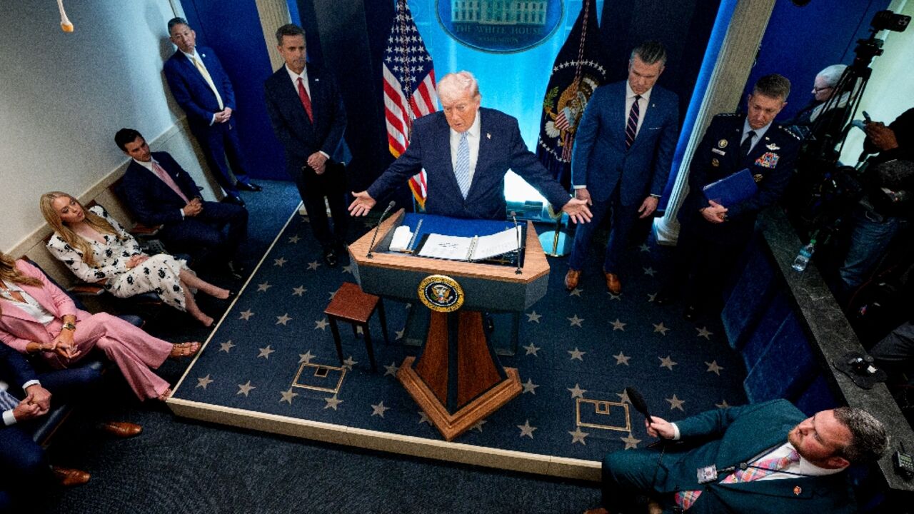 US President Donald Trump -- accompanied by CIA Director John Ratcliffe (C-L), Secretary of Defense Pete Hegseth (2nd-R) and Chairman of the Joint Chiefs of Staff General Dan Caine (R) -- speaks during a news conference at the White House on April 06, 2026
