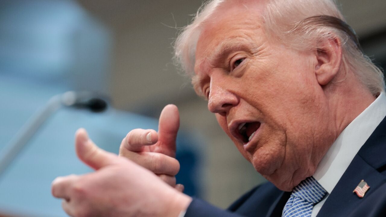 US President Donald Trump mimics firing a gun as he speaks in the White House about the war against Iran